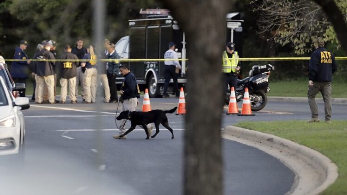 Officials work and stage near the site of Sunday's deadly explosion, Monday, March 19, 2018, in Austin, Texas. Police warned nearby residents to remain indoors overnight as investigators looked for possible links to other package bombings elsewhere in the city this month. (AP Photo/Eric Gay)