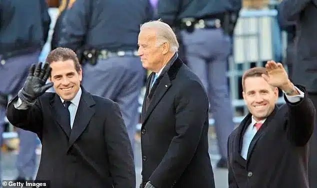 Emails obtained by Hunter Biden's laptop show Joe Biden would use three pseudonyms: 'Robin Ware,' 'Robert L. Peters' and 'JRB ware' when emailing his two sons, Hunter, left and Beau, right. They are pictured at Obama's Inaugural Parade in January 2009